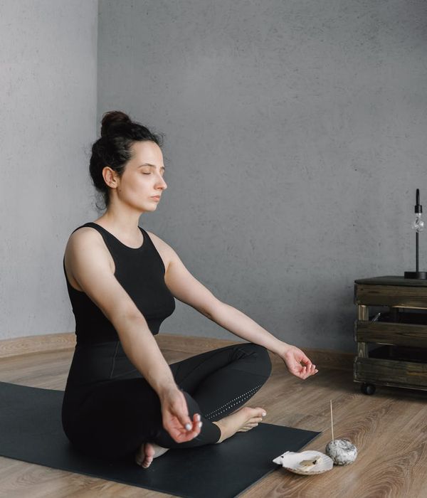 Woman feeling energized and balanced in a bright, modern space.